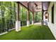 Expansive backyard featuring a covered patio, artificial turf, and stunning views of the forest at 306 Pinecrest Ne Rd, Atlanta, GA 30342