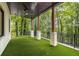 Scenic backyard with a covered patio, artificial turf, and views of lush greenery at 306 Pinecrest Ne Rd, Atlanta, GA 30342