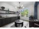 Stylish bar area with dark cabinets, marble countertop, and a modern light fixture at 306 Pinecrest Ne Rd, Atlanta, GA 30342