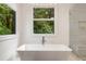 Modern bathroom with soaking tub under the window and glass enclosed shower at 306 Pinecrest Ne Rd, Atlanta, GA 30342