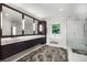 Bright primary bathroom featuring double vanity, standalone tub, and frameless shower at 306 Pinecrest Ne Rd, Atlanta, GA 30342