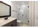 Bright bathroom with white subway tile shower, glass door, and modern vanity at 306 Pinecrest Ne Rd, Atlanta, GA 30342