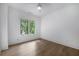 An airy bedroom with hardwood floors and a window with a view of the surrounding green trees at 306 Pinecrest Ne Rd, Atlanta, GA 30342