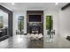 The dining room features a stone fireplace, mantle mounted television, and two symmetrical windows at 306 Pinecrest Ne Rd, Atlanta, GA 30342