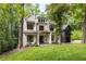 Charming two-story home with stone facade, arched entryway, and beautifully landscaped front yard at 306 Pinecrest Ne Rd, Atlanta, GA 30342