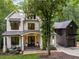 Beautiful stone house with a metal roof, a front porch with swing, and attached garage at 306 Pinecrest Ne Rd, Atlanta, GA 30342