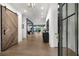 Spacious home foyer with hardwood floors and a modern barn door at 306 Pinecrest Ne Rd, Atlanta, GA 30342