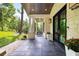 Inviting covered porch with stone columns, gray tile floor, and a porch swing at 306 Pinecrest Ne Rd, Atlanta, GA 30342