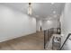 Bright hallway with hardwood floors, modern light fixture, and black metal railing at 306 Pinecrest Ne Rd, Atlanta, GA 30342