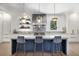 Gourmet kitchen features a marble island with seating and contemporary pendant lighting at 306 Pinecrest Ne Rd, Atlanta, GA 30342