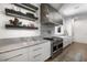 The modern kitchen features a stainless vent hood and range along with a matching marble backsplash at 306 Pinecrest Ne Rd, Atlanta, GA 30342