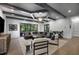 Bright living room features beamed ceilings, hardwood floors, and a leather sectional, creating an inviting space at 306 Pinecrest Ne Rd, Atlanta, GA 30342