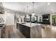 Open concept living space with modern chef's kitchen, dining room, and fireplace at 306 Pinecrest Ne Rd, Atlanta, GA 30342