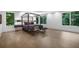 Modern bedroom featuring hardwood floors, a four-poster bed, and scenic views at 306 Pinecrest Ne Rd, Atlanta, GA 30342