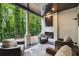 Inviting covered patio featuring a painted brick fireplace, ceiling fan, and comfortable seating at 306 Pinecrest Ne Rd, Atlanta, GA 30342