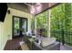 Inviting covered patio with cozy seating, perfect for relaxing and enjoying the lush, green surroundings at 306 Pinecrest Ne Rd, Atlanta, GA 30342
