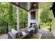 Covered patio with comfortable seating and an outdoor fireplace, ideal for enjoying the serene backyard views at 306 Pinecrest Ne Rd, Atlanta, GA 30342