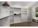 Walk-in closet with custom built-in shelving and storage solutions and a window seat at 306 Pinecrest Ne Rd, Atlanta, GA 30342