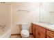 Bathroom featuring a vanity with wooden drawers, mirror, toilet, and tub with shower at 3440 Quinn Ridge Dr, Snellville, GA 30039