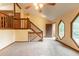 Spacious living room with unique windows, a staircase to the upper floor, and an open floorplan at 3440 Quinn Ridge Dr, Snellville, GA 30039