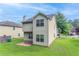 Exterior view of the home featuring a backyard and a grassy lawn at 3469 Stoneleigh Walk, Lithonia, GA 30038