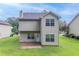 Exterior view of the home featuring a backyard with a grassy lawn at 3469 Stoneleigh Walk, Lithonia, GA 30038