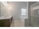 Bright bathroom featuring double sinks, a soaking tub, and a separate shower with glass doors at 3469 Stoneleigh Walk, Lithonia, GA 30038
