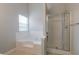 Bathroom features a tub, shower stall, and a window for natural light, creating a relaxing space at 3469 Stoneleigh Walk, Lithonia, GA 30038