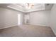 Spacious bedroom featuring a tray ceiling, neutral color palette, and plush carpeting throughout at 3469 Stoneleigh Walk, Lithonia, GA 30038