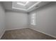 Bedroom features a tray ceiling, neutral color palette, and plush carpeting throughout at 3469 Stoneleigh Walk, Lithonia, GA 30038