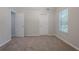 Neutral-colored bedroom with a ceiling fan and two windows at 3469 Stoneleigh Walk, Lithonia, GA 30038