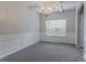 Airy dining room with a coffered ceiling, modern chandelier, and decorative wall trim at 3469 Stoneleigh Walk, Lithonia, GA 30038