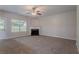 Spacious living room with a cozy fireplace and large windows for natural light at 3469 Stoneleigh Walk, Lithonia, GA 30038