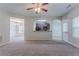 Open-concept living area with carpeted floors, neutral paint, and views of the dining space at 3469 Stoneleigh Walk, Lithonia, GA 30038