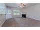 Bright living room featuring an open layout, a fireplace, and an adjacent doorway at 3469 Stoneleigh Walk, Lithonia, GA 30038