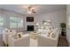 Inviting living room with modern furnishings, a cozy fireplace, and lots of natural light at 3469 Stoneleigh Walk, Lithonia, GA 30038