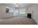Bright living room with a fireplace, a view of the kitchen, and a neutral color palette at 3469 Stoneleigh Walk, Lithonia, GA 30038