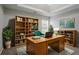 Bright home office with large desk, bookcase, and decor for a productive work environment at 3469 Stoneleigh Walk, Lithonia, GA 30038