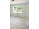 Unfinished bedroom with a dual window that provides ample natural light and views of the yard at 1257 Pj East Rd, Covington, GA 30014