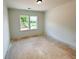 Unfinished bedroom featuring a window that overlooks the yard with potential for customization at 1257 Pj East Rd, Covington, GA 30014