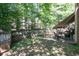 Backyard patio features a retractable awning, dark metal patio furniture, and a privacy fence, perfect for outdoor relaxation at 4003 Maple Ridge Nw Ln, Acworth, GA 30101