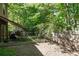 Spacious backyard with patio area, wooden fence, mature trees, and lush greenery providing privacy at 4003 Maple Ridge Nw Ln, Acworth, GA 30101
