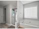 Bathroom showcasing a soaking tub, separate shower, and a window with blinds allowing natural light at 4003 Maple Ridge Nw Ln, Acworth, GA 30101