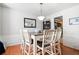 Bright dining room with views into the kitchen featuring an adjacent bar and hardwood floors at 4003 Maple Ridge Nw Ln, Acworth, GA 30101