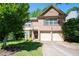 Traditional two-story brick home featuring an attached two-car garage and a well maintained lawn at 4003 Maple Ridge Nw Ln, Acworth, GA 30101