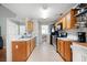 Efficient kitchen layout with tile floors, appliances, and access to dining and living areas at 4003 Maple Ridge Nw Ln, Acworth, GA 30101