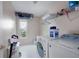 Well-organized laundry room with modern washer and dryer, storage shelves, and natural light from a window at 4003 Maple Ridge Nw Ln, Acworth, GA 30101