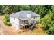 Back exterior featuring a screened porch, wood deck with stairs, and a 2-car garage at 567 Leah Drive, Powder Springs, GA 30127
