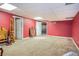 Unfinished basement with concrete floors and red walls providing opportunity to customize the space to homeowner taste at 567 Leah Drive, Powder Springs, GA 30127