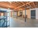 Unfinished basement showcasing exposed wood beams and steel support beams that can be transformed into livable space at 567 Leah Drive, Powder Springs, GA 30127